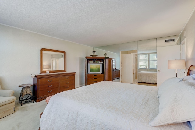 carpeted bedroom with a textured ceiling