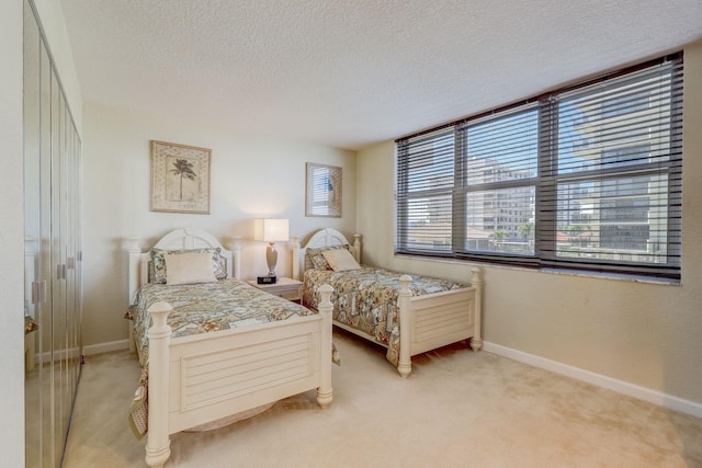 bedroom featuring carpet and a textured ceiling