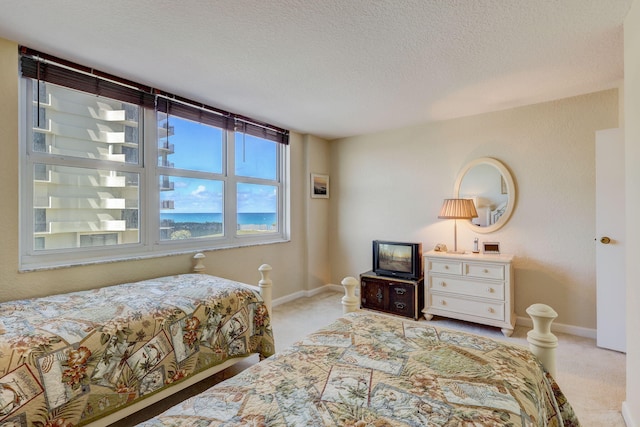 carpeted bedroom featuring a textured ceiling