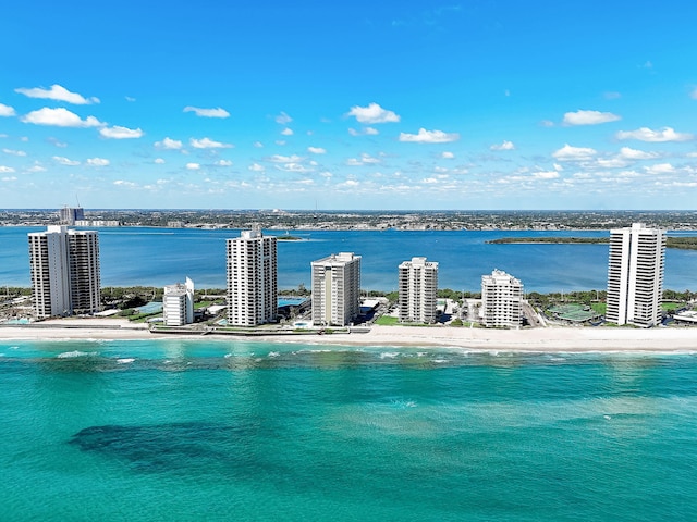 bird's eye view featuring a water view and a beach view