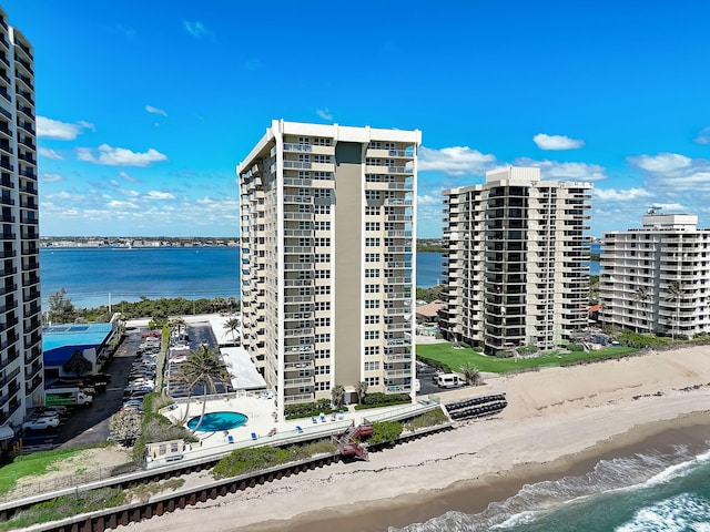 view of property featuring a water view and a view of the beach