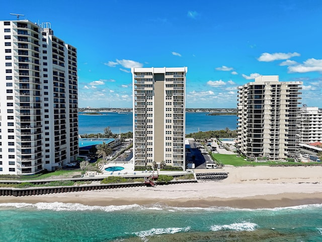 exterior space with a water view and a beach view