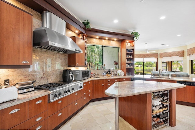 kitchen with stainless steel appliances, decorative backsplash, a center island, wall chimney exhaust hood, and sink