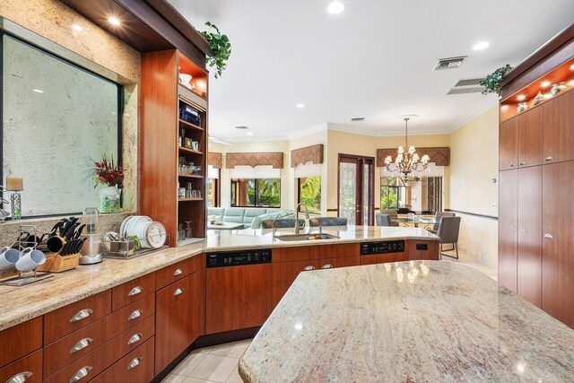 kitchen featuring dishwasher, a chandelier, pendant lighting, light stone counters, and sink