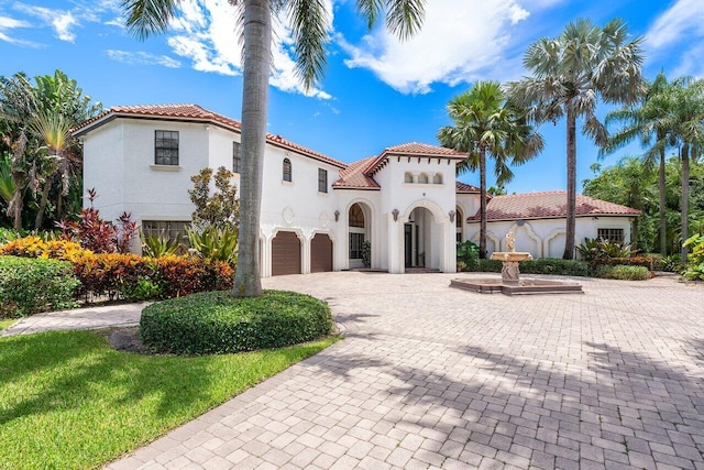 mediterranean / spanish-style home featuring a garage