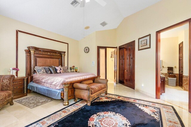 bedroom featuring ceiling fan, ensuite bathroom, and lofted ceiling