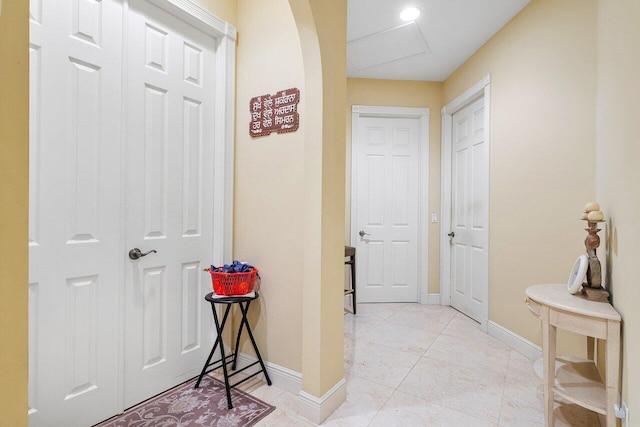 corridor with light tile patterned floors