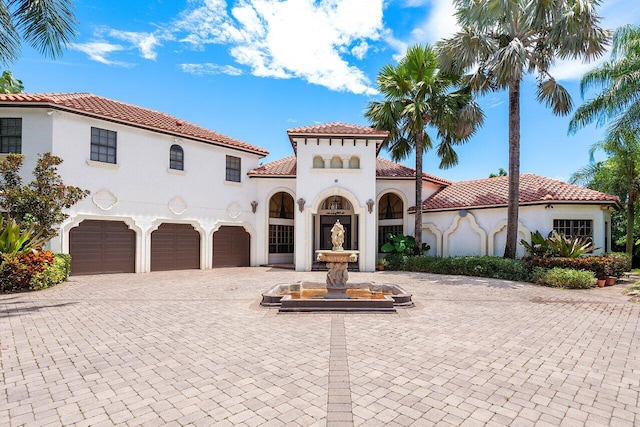 mediterranean / spanish house featuring a garage