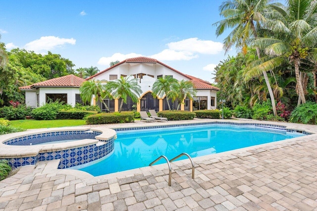 view of swimming pool featuring an in ground hot tub