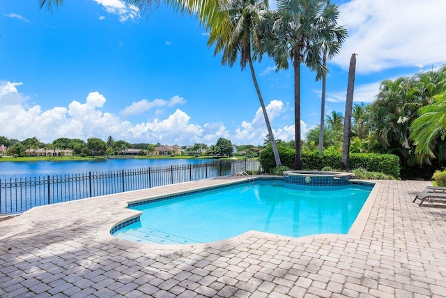 view of swimming pool with a water view, an in ground hot tub, and a patio