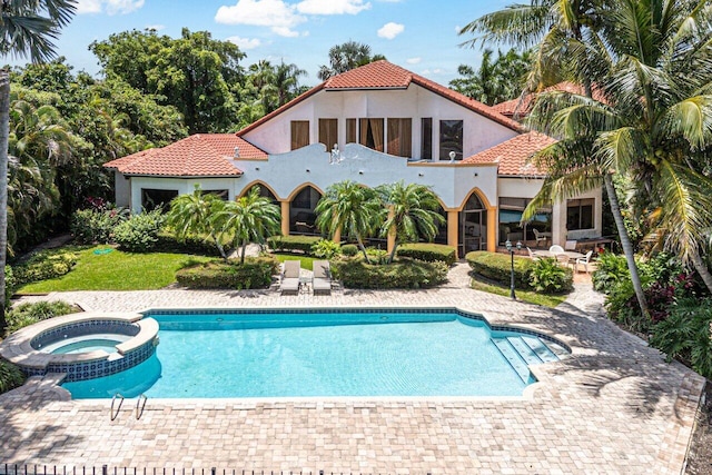 view of swimming pool with a patio area and an in ground hot tub