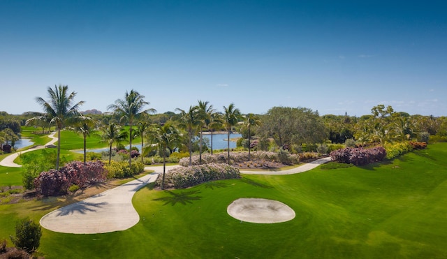 view of home's community with a lawn and a water view