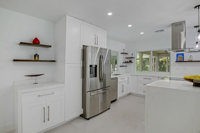 kitchen with light stone counters, hanging light fixtures, island exhaust hood, white cabinets, and appliances with stainless steel finishes