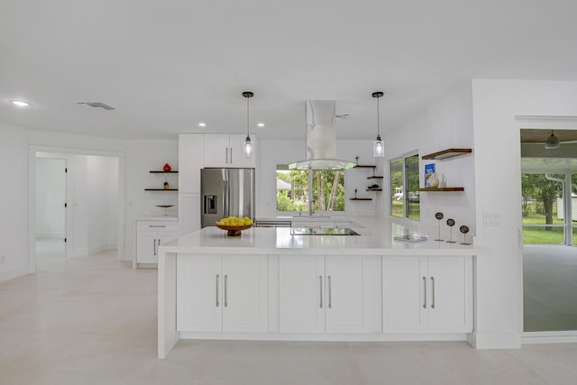 kitchen featuring black electric cooktop, island range hood, pendant lighting, and stainless steel fridge with ice dispenser