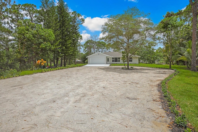 view of front of house with a front yard and a garage