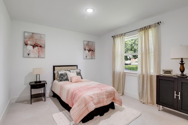 bedroom featuring light carpet