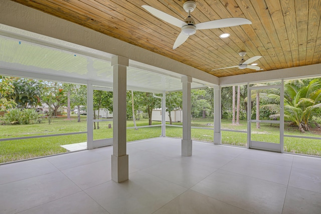 unfurnished sunroom featuring ceiling fan and wooden ceiling