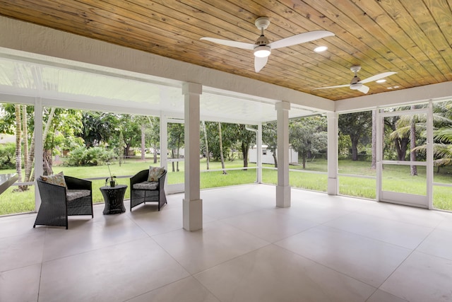 unfurnished sunroom featuring ceiling fan and wooden ceiling