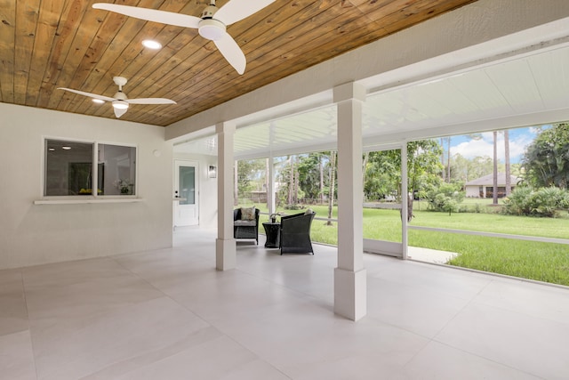 unfurnished sunroom featuring ceiling fan and wooden ceiling