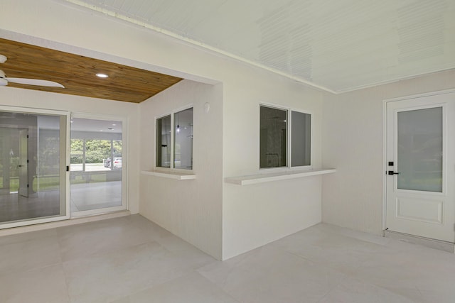 entrance to property with a patio area and ceiling fan