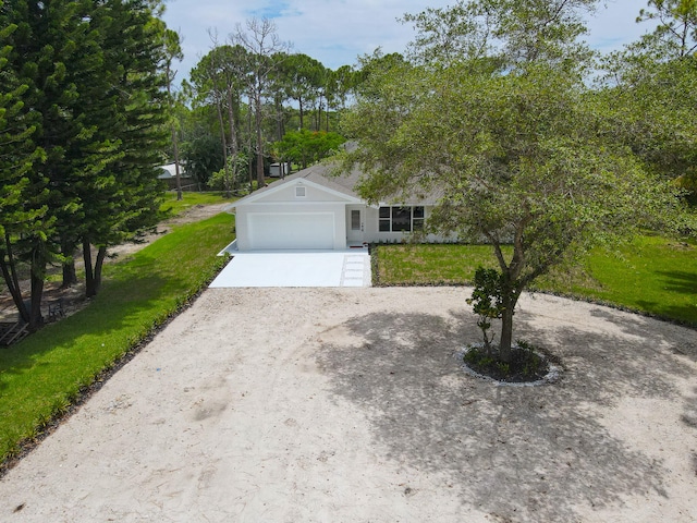 view of front of home with a front lawn and a garage