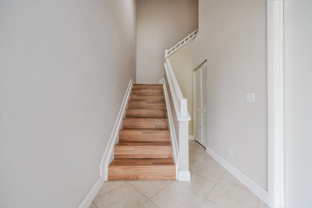 stairway with light tile patterned floors