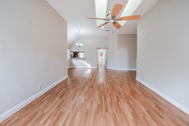 unfurnished living room with lofted ceiling, light hardwood / wood-style floors, and ceiling fan with notable chandelier