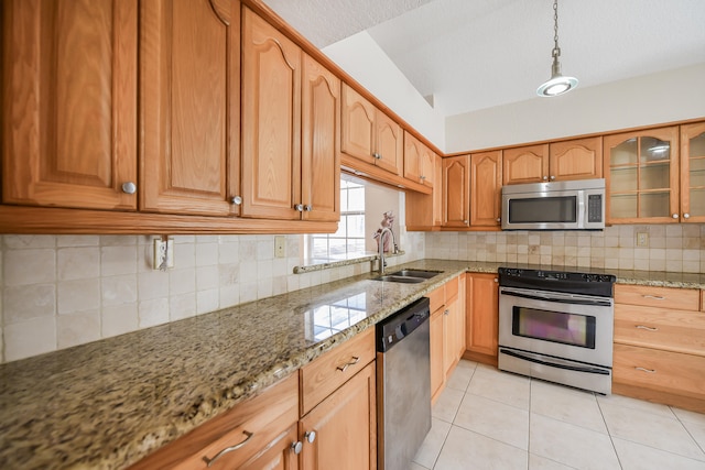 kitchen featuring light stone countertops, stainless steel appliances, and backsplash