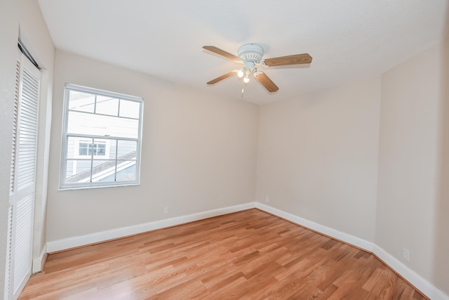 spare room featuring light wood-type flooring, ceiling fan, and a healthy amount of sunlight