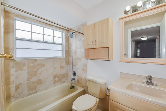 full bathroom featuring toilet, tiled shower / bath combo, and vanity