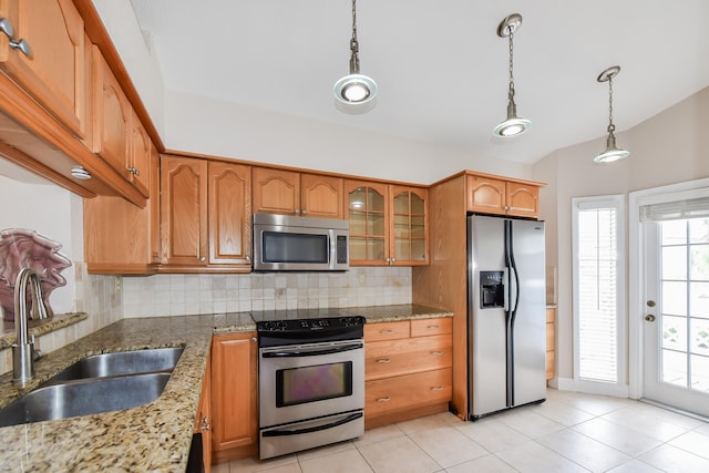 kitchen with stone counters, light tile patterned floors, tasteful backsplash, and stainless steel appliances