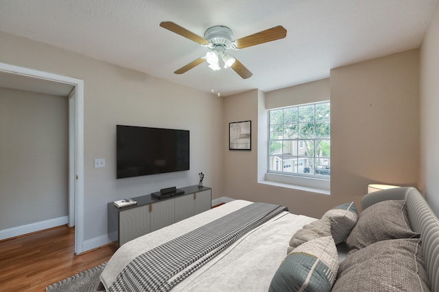 bedroom with wood-type flooring and ceiling fan