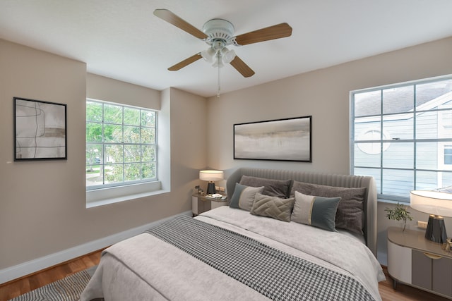 bedroom with ceiling fan and hardwood / wood-style flooring