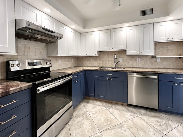 kitchen featuring sink, white cabinets, light tile patterned floors, stainless steel appliances, and blue cabinetry