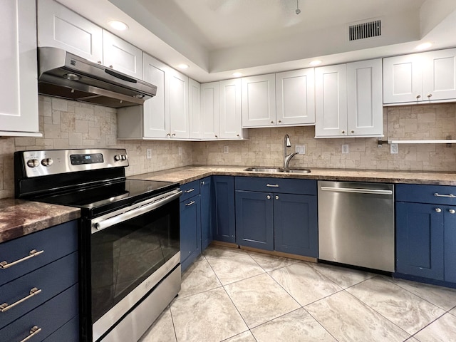 kitchen featuring sink, stainless steel appliances, blue cabinets, and light tile patterned floors