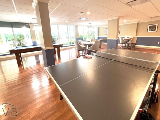 recreation room featuring expansive windows, wood-type flooring, a drop ceiling, and billiards