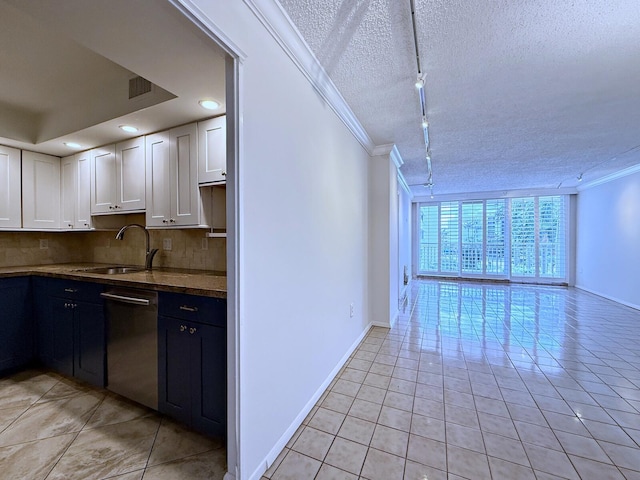 kitchen featuring white cabinetry, dishwasher, sink, and a textured ceiling