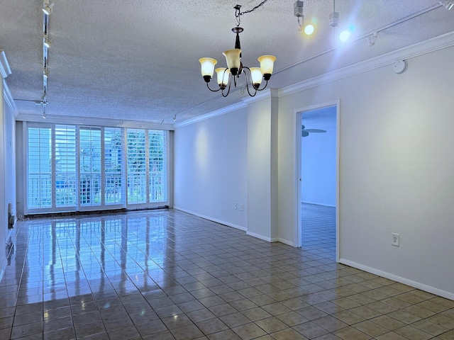 tiled spare room with a notable chandelier, a wall of windows, ornamental molding, and a textured ceiling