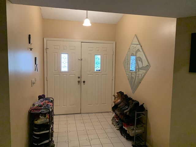 entryway with light tile patterned floors