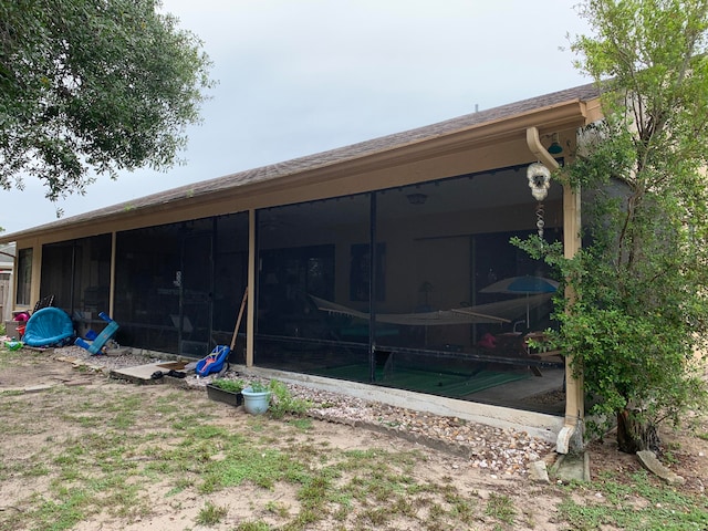 rear view of property with a sunroom