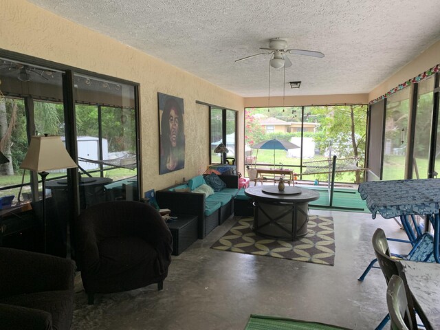 sunroom / solarium featuring ceiling fan