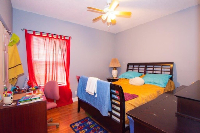 bedroom with wood-type flooring and ceiling fan