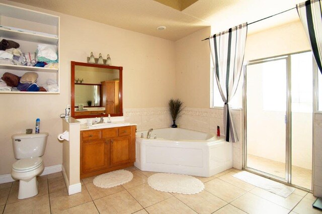 1640 SW Burlington St, Port Saint Lucie, FL 34984 - full bathroom with tile patterned floors, vanity, a garden tub, and toilet