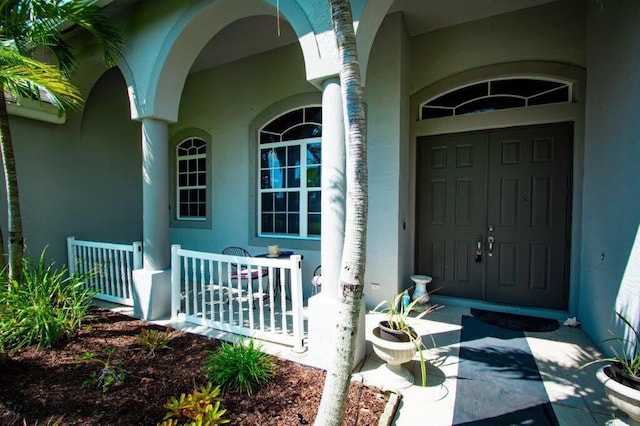1640 SW Burlington St, Port Saint Lucie, FL 34984 - property entrance with covered porch and stucco siding