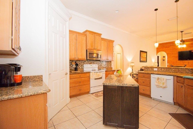 1640 SW Burlington St, Port Saint Lucie, FL 34984 - kitchen with white appliances, arched walkways, decorative backsplash, ornamental molding, and a center island