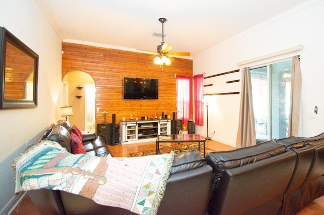 living room with ornamental molding, a healthy amount of sunlight, and ceiling fan