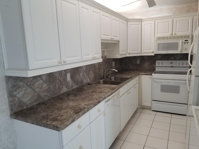 kitchen with decorative backsplash, white cabinetry, sink, and white appliances