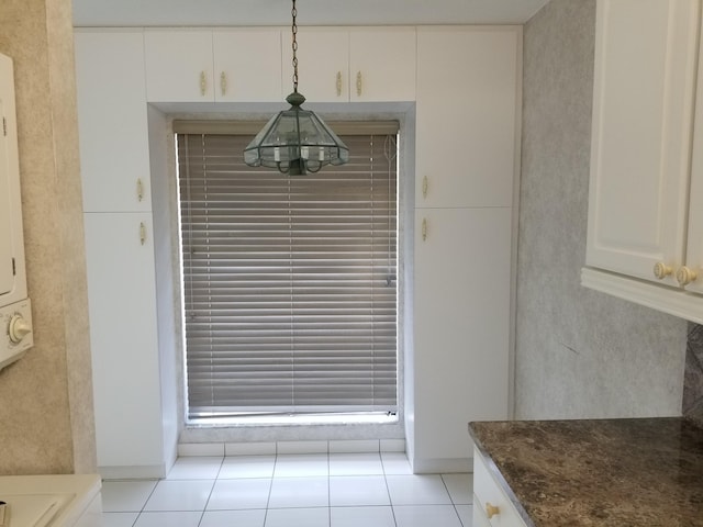 unfurnished dining area featuring light tile patterned floors