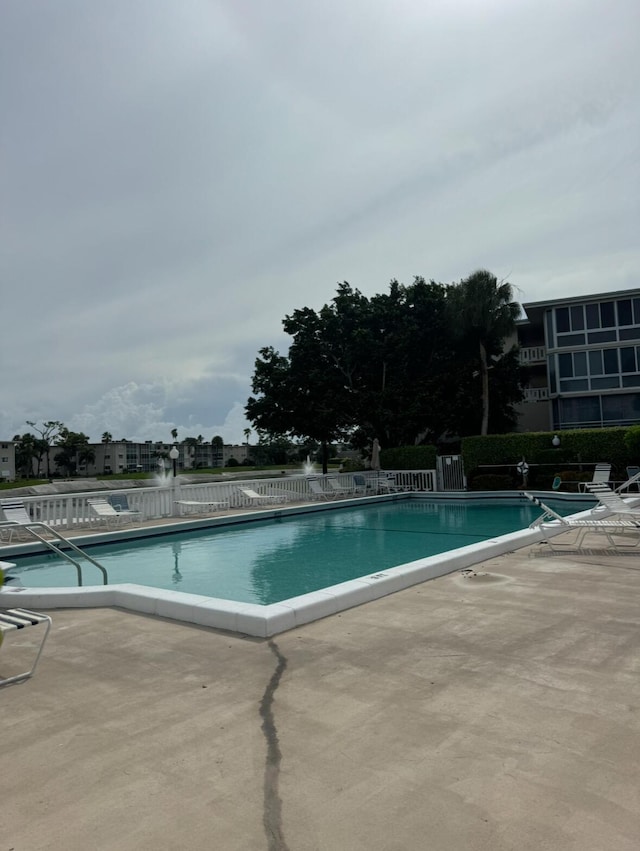 view of swimming pool with a patio