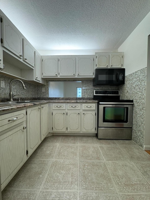 kitchen with sink, cream cabinets, a textured ceiling, and stainless steel electric range oven